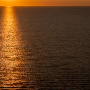 Roland Seichter Fotografie - Einzigartige Wandbilder - Fotografie mit Wasser - Fotografie der untergehenden Sonne über dem Meer, Die haupsächliche Farbe ist orange