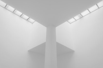 Roland Seichter Fotografie - Architekturfotografie - Symmetrische Architektur mit diagonalen Fensterflächen in der Decke. Schwarz/Weiß