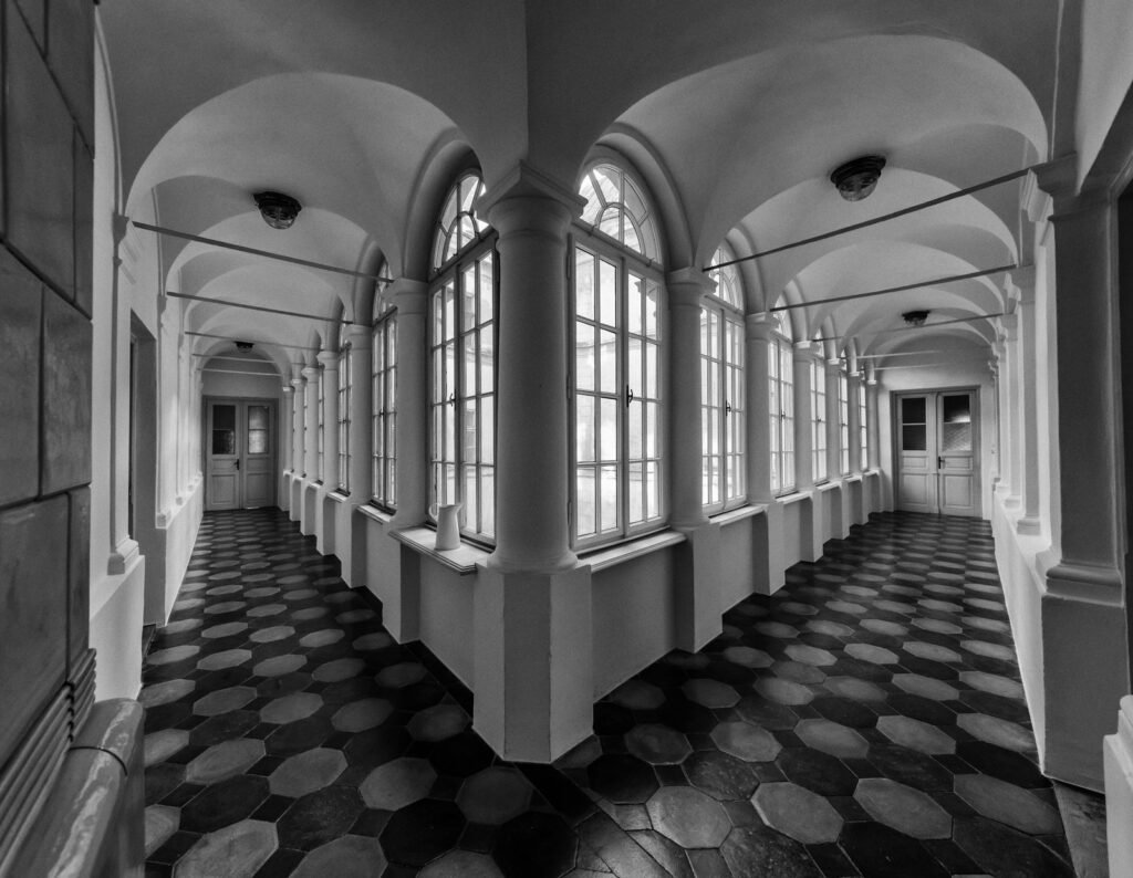 Rechtwinkliger Flur eines alten Herrschaftshauses in Weitwinkel-Perspektive.