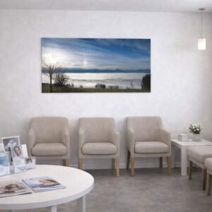 Blick vom Auerberg am Morgen Das Wandbild Blick vom Auerberg am Morgen im 16:9 Panorama-Format als raumöffnendes und beruhigendes Kunstwerk an der Wand eines hellen Wartezimmers.